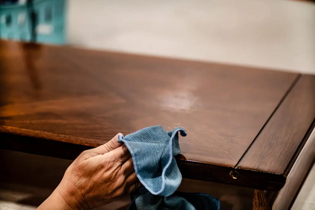 CRS employee wiping down table