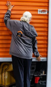 CRS Employee standing next to a orange storage garage door
