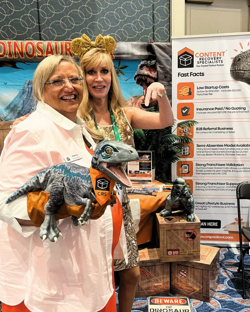 Nancy Haverty poses with Alesia Visconti, CEO of Franserve, in front of the CRS booth at the Franserve Conference