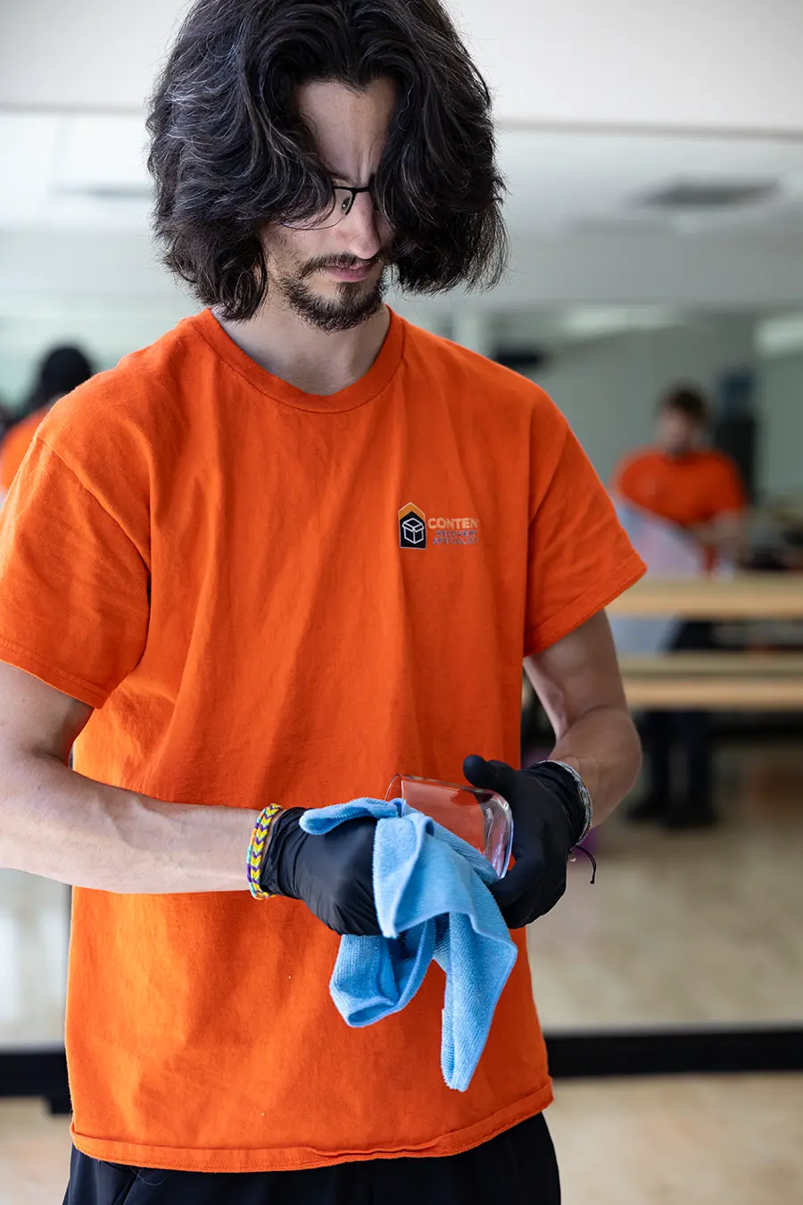 Content Recovery Specialists hand cleaning a glass