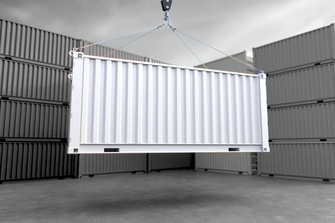 An industrial storage container being lifted